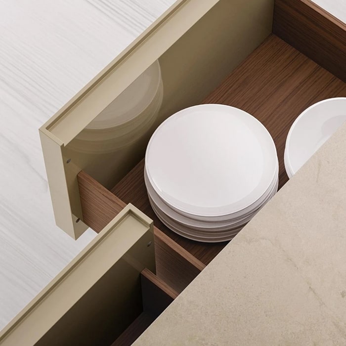 Stack of white ceramic plates in kitchen drawer with wooden interior.