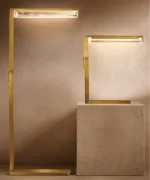 Modern LED lighting fixtures with sleek gold frames on a neutral background.