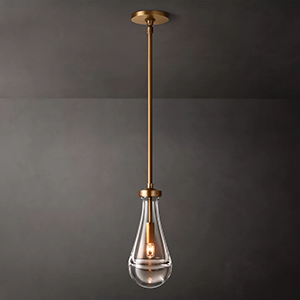 Modern pendant light with a clear glass teardrop shade and metallic accents.