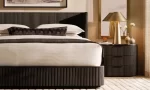 Elegant bedroom with Gorvey lighting and round metal table lamp.