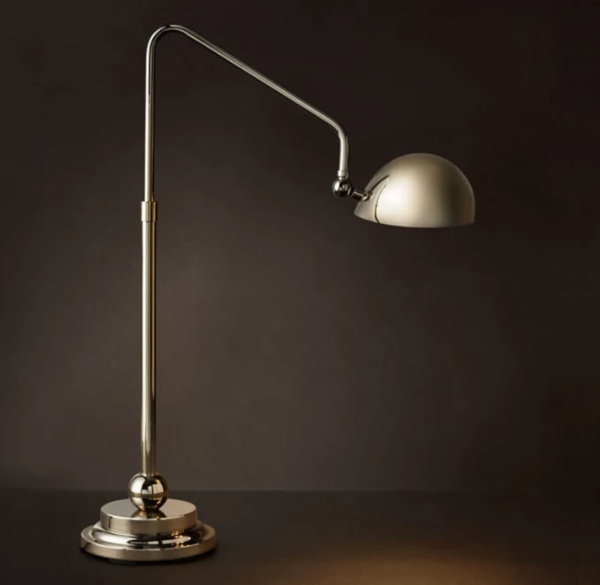 Modern Gorvey table lamp with adjustable arm and metallic finish.