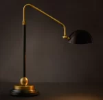 Modern black and gold task table lamp with adjustable arm for desk lighting.