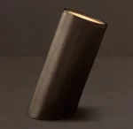 Sleek black cylindrical lamp with warm interior lighting for modern decor.