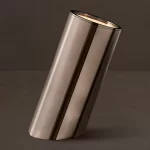 Sleek metallic vase with a reflective surface for modern decor.