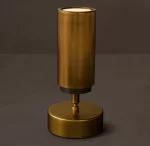 Modern gold spotlight with cylindrical design for interior lighting.
