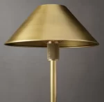 Elegant gold metal shade table lamp with textured stem for modern decor.