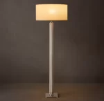 Modern Gorvey lighting floor lamp with a sleek knurled metal stand and a beige lampshade.