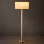 Modern Gorvey lighting floor lamp with a sleek knurled metal stand and a beige lampshade.