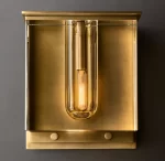 Modern gold wall sconce with cylindrical glass light fixture for elegant decor.