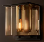 Gorvey lighting fixture with a modern, reflective design and warm Edison bulb.