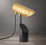 Modern Gorvey Champeaux folding spotlight with gold finish and black base.