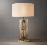 Elegant glass table lamp with smoke glass and gold accents for modern decor.