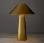 Modern gold table lamp with a conical shade for stylish lighting.