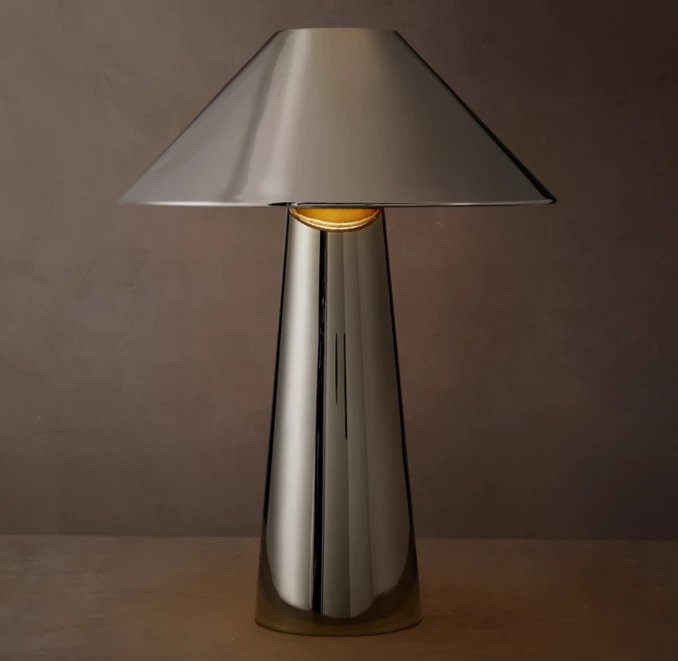 Sleek metallic table lamp with a conical shade and cylindrical base.