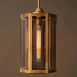 Modern pendant light with brass frame and glass panels for elegant decor.
