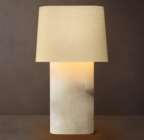 Gorvey modern stone lamp with linen oval shade on dark background.