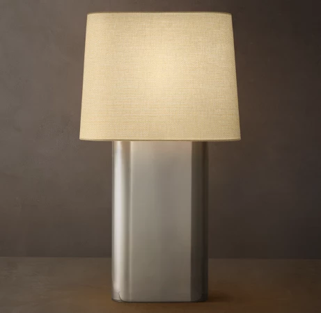 Gorvey lighting modern metal lamp with linen shade on a dark background.