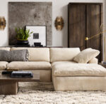 Modern living room with Gorvey lighting, beige sofa, and contemporary decor.