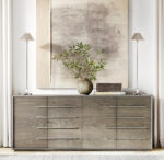 Elegant wooden sideboard with metallic handles and decorative items.