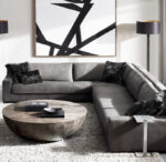 Modern living room with Gorvey lighting, gray sofa, and abstract wall art.