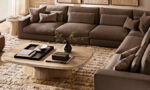 Modern living room with neutral-toned sofa and wooden coffee table.