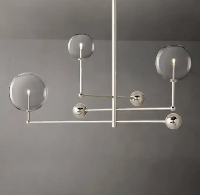 Modern chandelier with glass globes and metallic accents for stylish lighting.