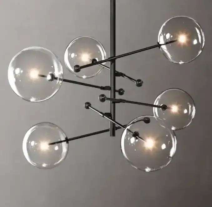 Modern chandelier with glass globes and black metal arms for stylish lighting.