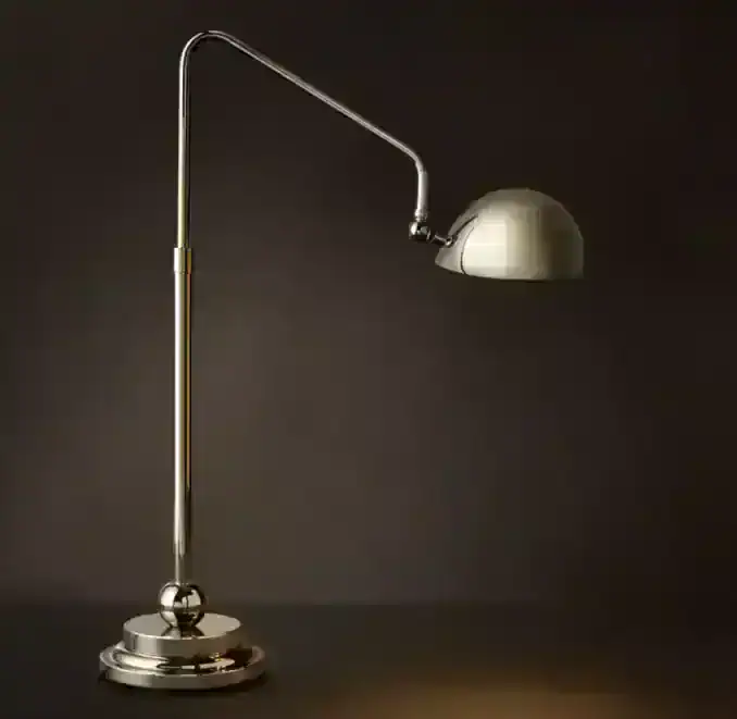 Modern metallic desk lamp with adjustable arm and dome shade for office or study.