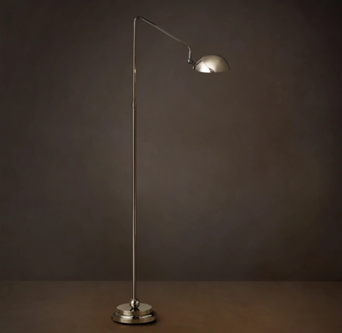 Sleek silver floor lamp with adjustable arm and dome shade for modern interiors.