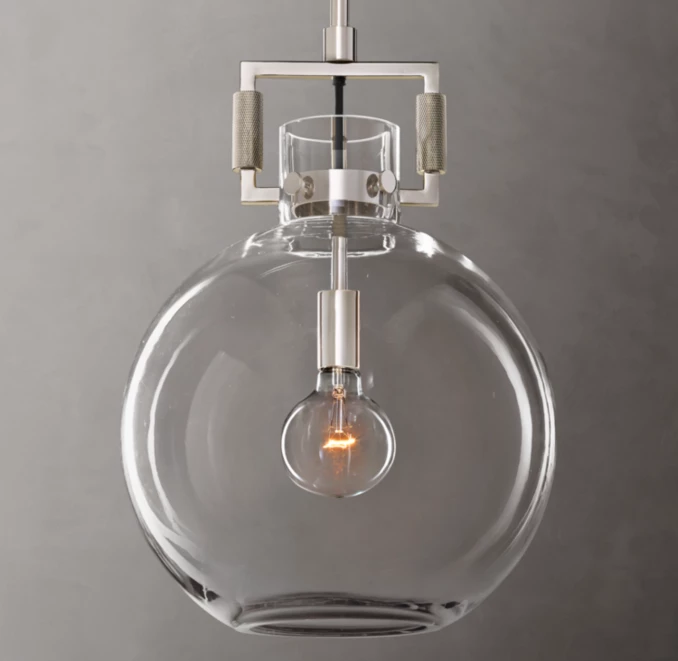 Elegant glass pendant lamp with visible filament bulb for modern lighting design.
