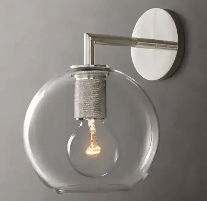 Contemporary glass wall lamp with exposed filament bulb for stylish lighting.