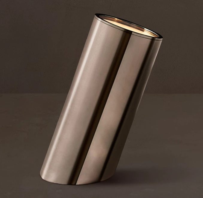 Sleek metallic vase with a tilted design for modern decor.