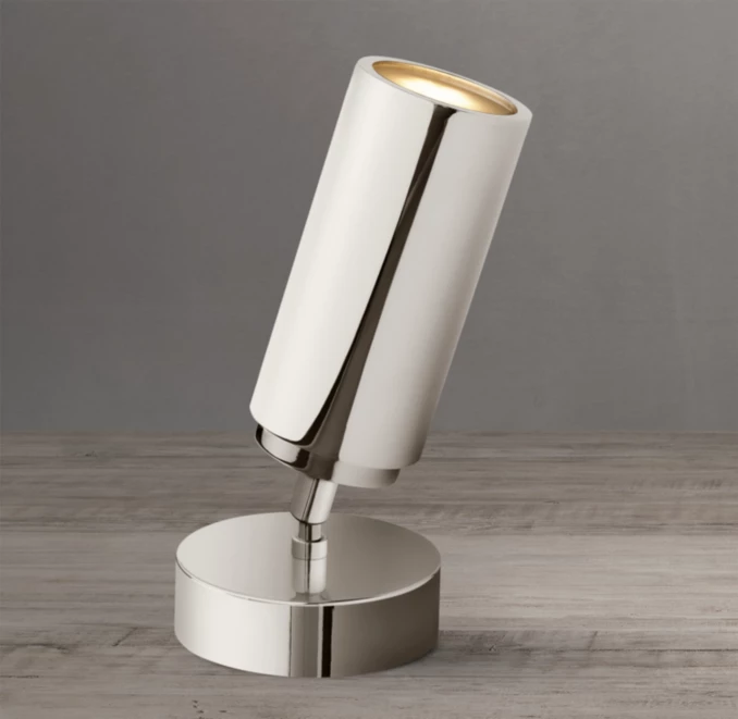 Contemporary white LED desk lamp with adjustable tilt for modern workspace.