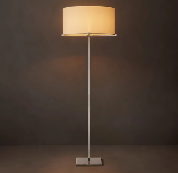 Elegant floor lamp with a beige lampshade and sleek metal stand.