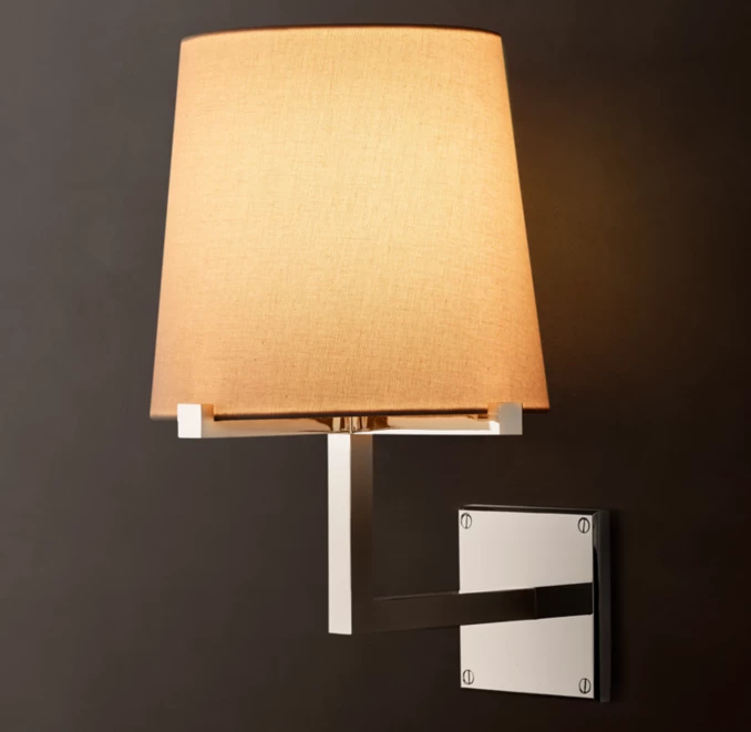 Modern wall lamp with beige lampshade and white mounting bracket.