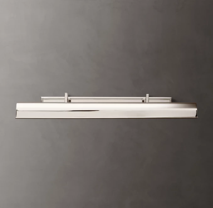 Modern white lighting fixture mounted on a gray wall.