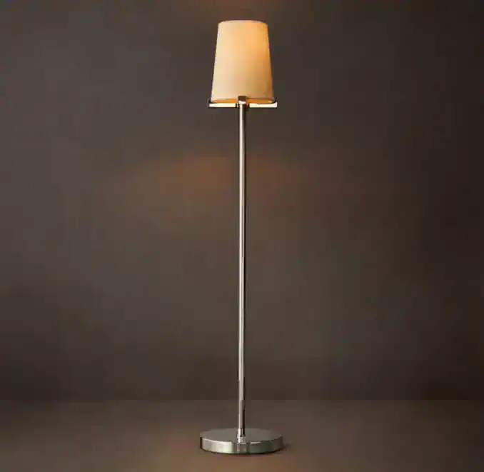 Modern floor lamp with a beige lampshade and sleek metal stand.