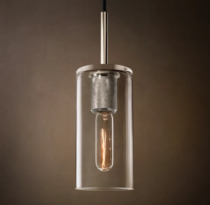 Elegant modern pendant light with glass enclosure and metallic accents.