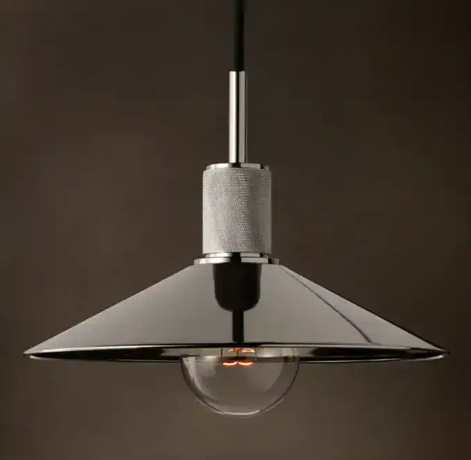 Modern pendant lamp with metallic shade and exposed bulb for stylish lighting.