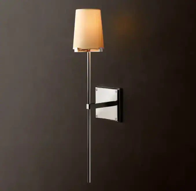 Modern wall lamp with beige lampshade and sleek black metal arm.