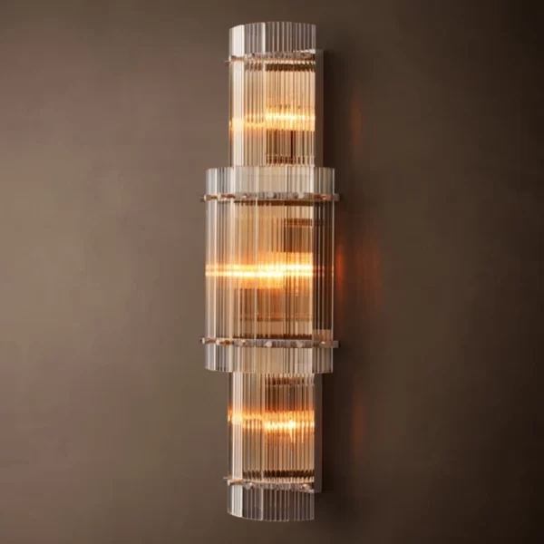 Elegant modern wall sconce with glass and warm lighting from Gorvey Lighting.