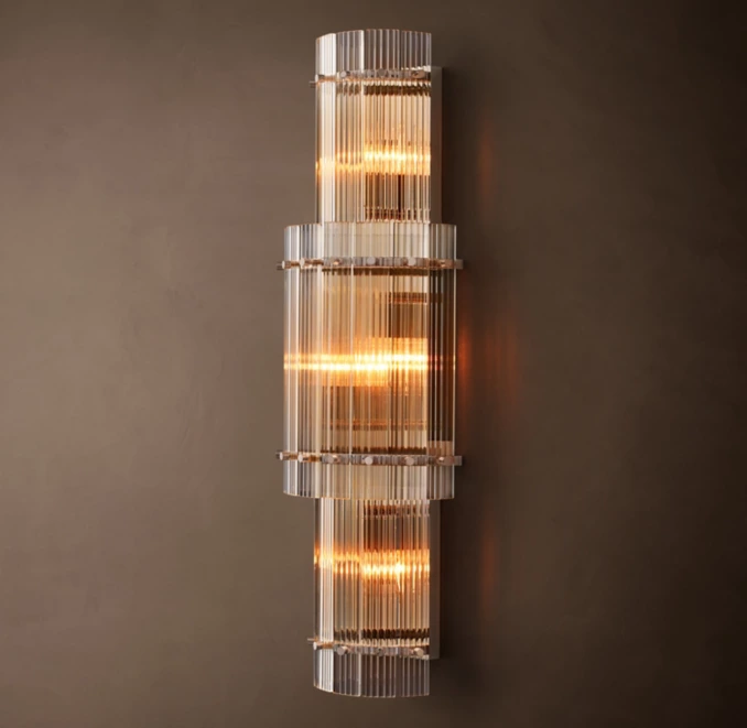Elegant modern wall sconce with glass and warm lighting from Gorvey Lighting.