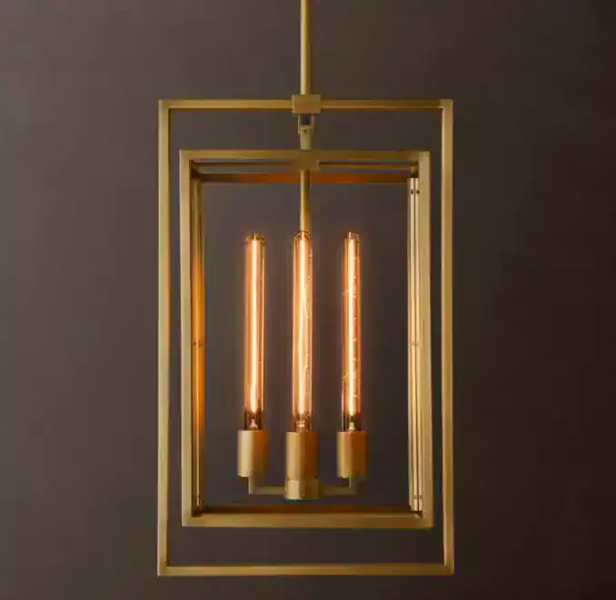 Elegant modern pendant light with three Edison bulbs and geometric gold frame.