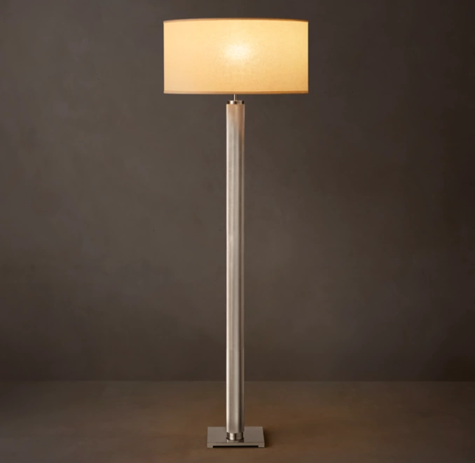 Elegant modern floor lamp with a beige lampshade and sleek metal stand.