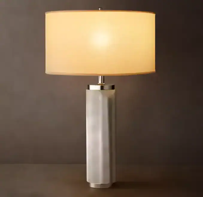 Modern table lamp with a white base and beige lampshade for home decor.