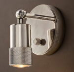 Sleek metallic wall lamp with adjustable arm and warm light.