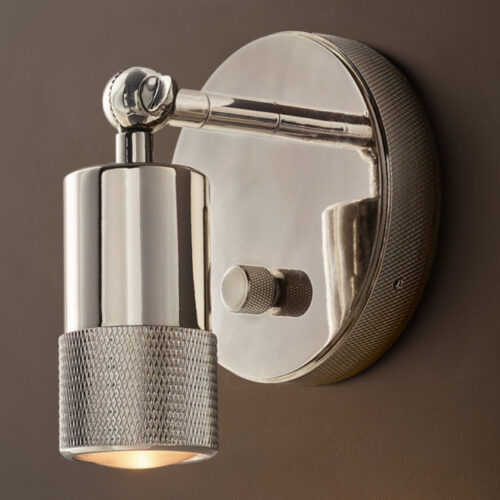 Sleek metallic wall lamp with adjustable arm and warm light.