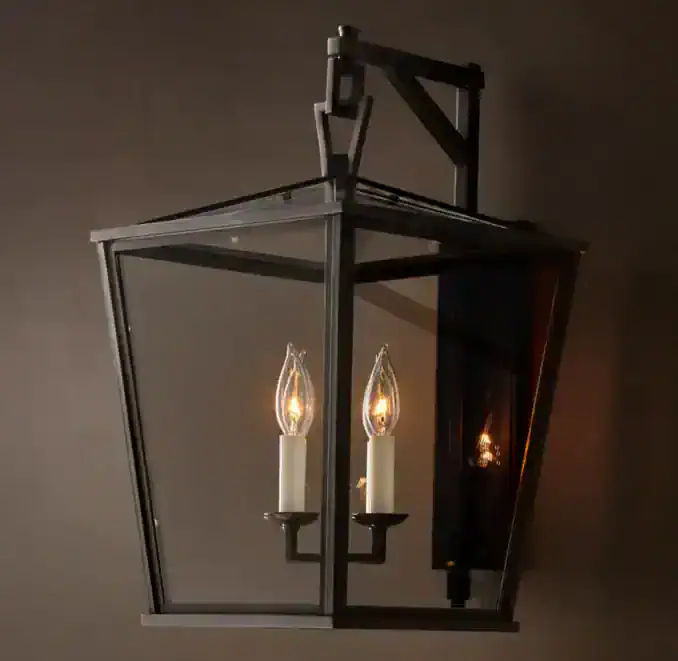 Elegant outdoor lantern with glass panels and candle-style bulbs.