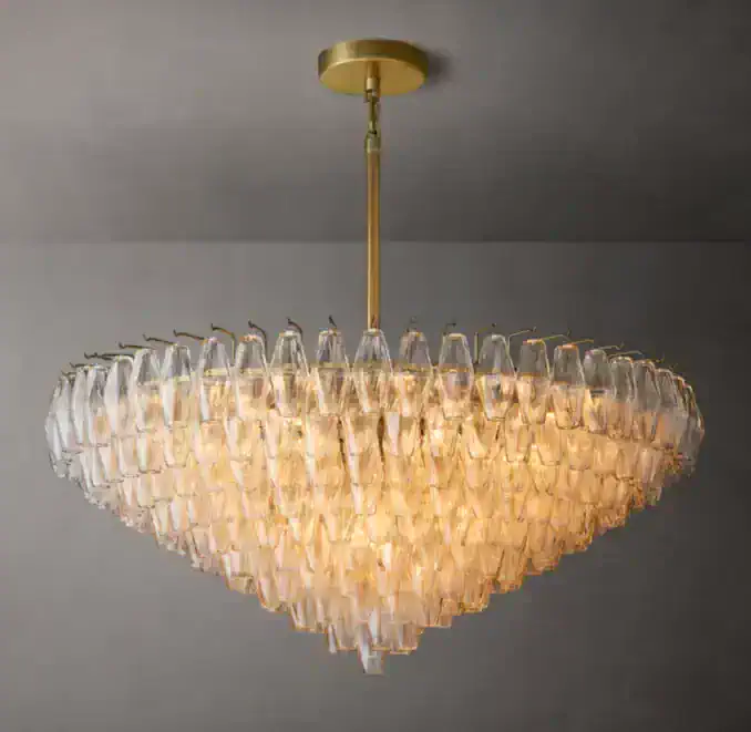 Elegant tiered glass chandelier with gold fixture for modern interiors.