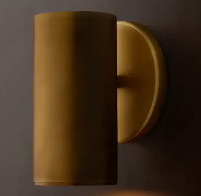 Contemporary wall lamp with a sleek gold finish for modern interiors.
